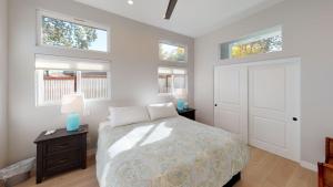 a bedroom with a bed and three windows at Twice is Nice by AvantStay in Paso Robles