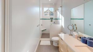 a white bathroom with a toilet and a shower at Twice is Nice by AvantStay in Paso Robles