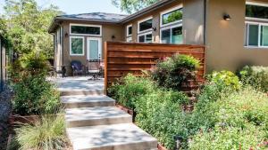 a house with a wooden fence in front of a yard at Twice is Nice by AvantStay in Paso Robles