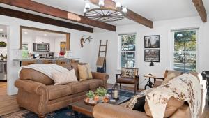 a living room with a couch and a table at 8 Mile House by AvantStay in Santa Margarita