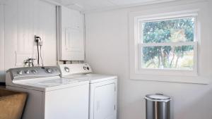 a white laundry room with a washer and a window at 8 Mile House by AvantStay in Santa Margarita +22 photos