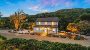 a house with lights on in a driveway at 8 Mile House by AvantStay in Santa Margarita