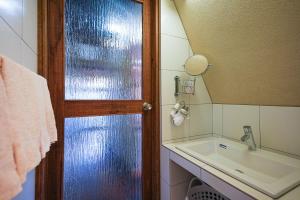 a bathroom with a sink and a mirror at Moon's Cafe in Onomichi +53 photos
