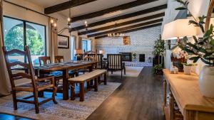 a dining room with a long table and chairs at Na Hoku Ranch by AvantStay in Atascadero