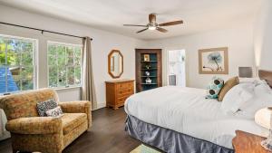 a bedroom with a bed and a chair and a ceiling fan at Chateau Paso by AvantStay in Paso Robles
