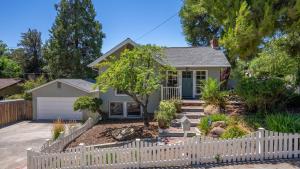 a white picket fence in front of a house at Chateau Paso by AvantStay in Paso Robles