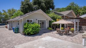 a house with a patio with a table and an umbrella at 13th Street Retreat by AvantStay in Paso Robles