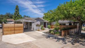 a home with a wooden fence and a driveway at 7th Street Sanctuary by AvantStay in Paso Robles