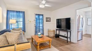 a living room with a couch and a flat screen tv at 7th Street Sanctuary by AvantStay in Paso Robles