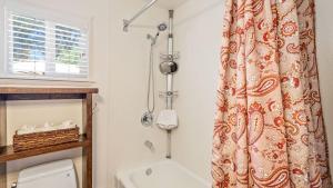 a bathroom with a toilet and a shower curtain at 7th Street Sanctuary by AvantStay in Paso Robles +13 photos