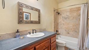 a bathroom with a sink and a tub and a toilet at Vita Amorosa by AvantStay in Atascadero +15 photos