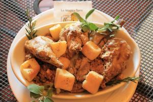 a bowl of food with meat and potatoes on a table at Affittacamere La Magica Torre in Pitigliano +9 photos