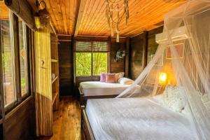 a bedroom with two beds and a window at Villa Tayrona in El Zaino +69 photos
