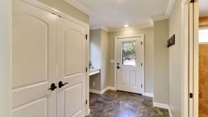 a hallway with a white door and a tile floor at Two Sweet by AvantStay in Paso Robles +27 photos