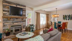 a living room with a couch and a fireplace at The Sycamore by AvantStay in Paso Robles