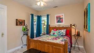 a bedroom with a wooden bed with blue curtains at The Sycamore by AvantStay in Paso Robles