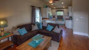 a living room with a couch and a table at Bliss House by AvantStay in Paso Robles