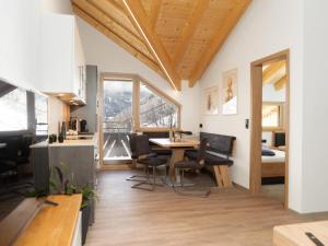 a kitchen and dining room with a table and chairs at Panoramic view apartment Kaunergrat in Kaunerberg +14 photos