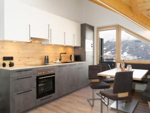 a kitchen with a table and a dining room at Panoramic view apartment Kaunergrat in Kaunerberg