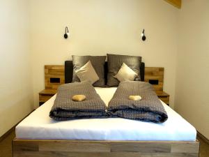 a bedroom with a bed with two pillows on it at Panoramic view apartment Kaunergrat in Kaunerberg