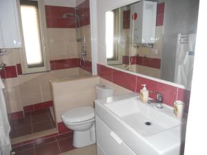 a bathroom with a white toilet and a sink at B&B Le Tre Gemme in Lentini