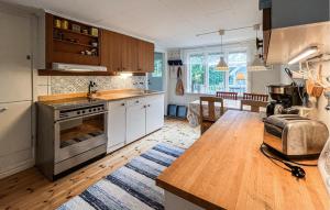 a kitchen with a stove and a counter top at 2 Bedroom Lovely Home In Ödeshög in Ödeshög