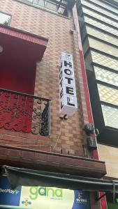 a sign on the side of a brick building at Hotel Nexo in Medellín
