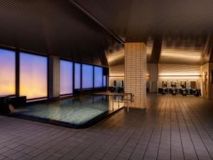 a large room with a pool in the middle of a building at Mercure Saga Karatsu Resort in Karatsu