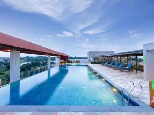 a swimming pool on the roof of a building at ibis Styles Mysuru in Mysore