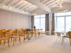a conference room with tables and chairs and windows at Novotel Narbonne Sud A9/A61 in Narbonne +202 photos