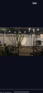 a patio with picnic tables and a white fence at Boho Chic in New Port Richey