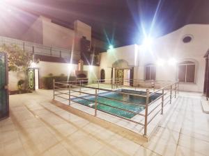 a swimming pool in the middle of a house with lights at استراحه الصفا in Medina