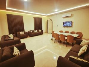 a living room with couches and a table and chairs at استراحه الصفا in Medina