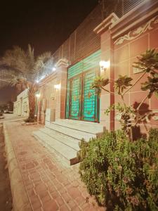 a building with blue doors on a street at night at استراحه الصفا in Medina