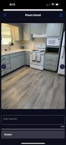 a kitchen with white appliances and a kitchen with wooden floors at Boho Chic in New Port Richey +5 photos