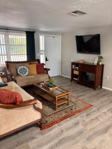 a living room with a couch and a table at Boho Chic in New Port Richey