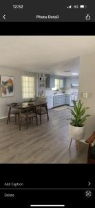 a living room with a table and a kitchen at Boho Chic in New Port Richey
