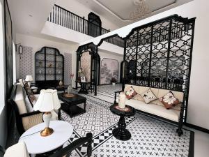 a living room with a couch and a table at Celine Privé - Dalat Hotel in Da Thien