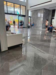 a person sitting on a couch in a lobby at Khách sạn L'Aur in Cửa Lô