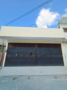 a garage with a large blue garage door at Guadalupe House Esquipulas in Esquipulas