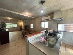 a kitchen with a sink and a counter top at Deer Path Nara in Nara