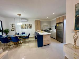 a kitchen and living room with a table and chairs at Villa Luminosa in Punta Cana