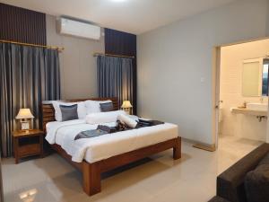a bedroom with a large bed and a bathroom at Sarining 2BR Villa With Pool in Uluwatu +32 photos