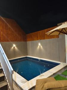 a large swimming pool in a room with at Sarining 2BR Villa With Pool in Uluwatu