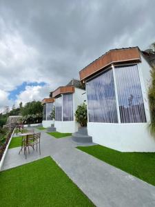 a patio with a table and chairs in front of a building at Jungle camping in Baturaja