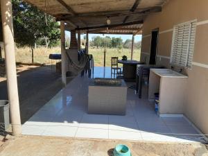 a covered patio with a table and chairs at Rancho do Véio in Aquidauana