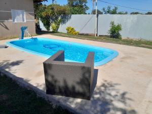 a small swimming pool with a chair next to it at Rancho do Véio in Aquidauana