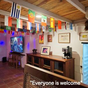 a room with flags on the wall and a television at Pinnacle of Everything in Kandy +7 photos