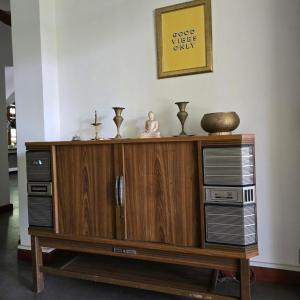 a wooden entertainment center with two servers on top of it at Pinnacle of Everything in Kandy