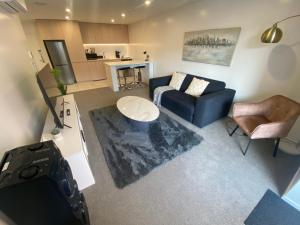 an overhead view of a living room with a couch and chair at Central City Views In Heart of Central Chch by Stadium in Christchurch
